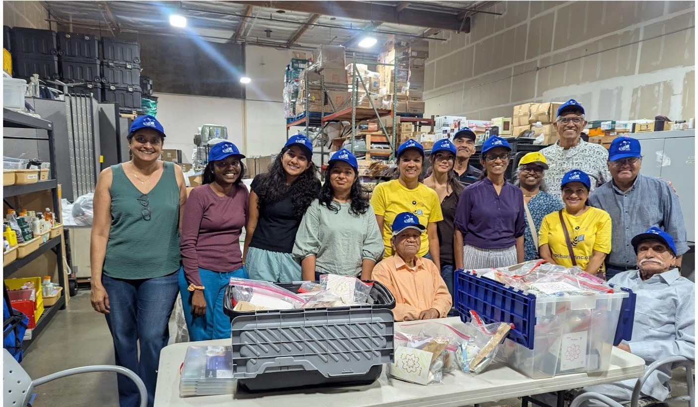 TAP volunteers at the packing tables inside the HomeFirst warehouse